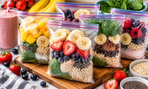Protein smoothie packs with berries, banana, spinach, oats, chia seeds, and protein powder for healthy meal prep